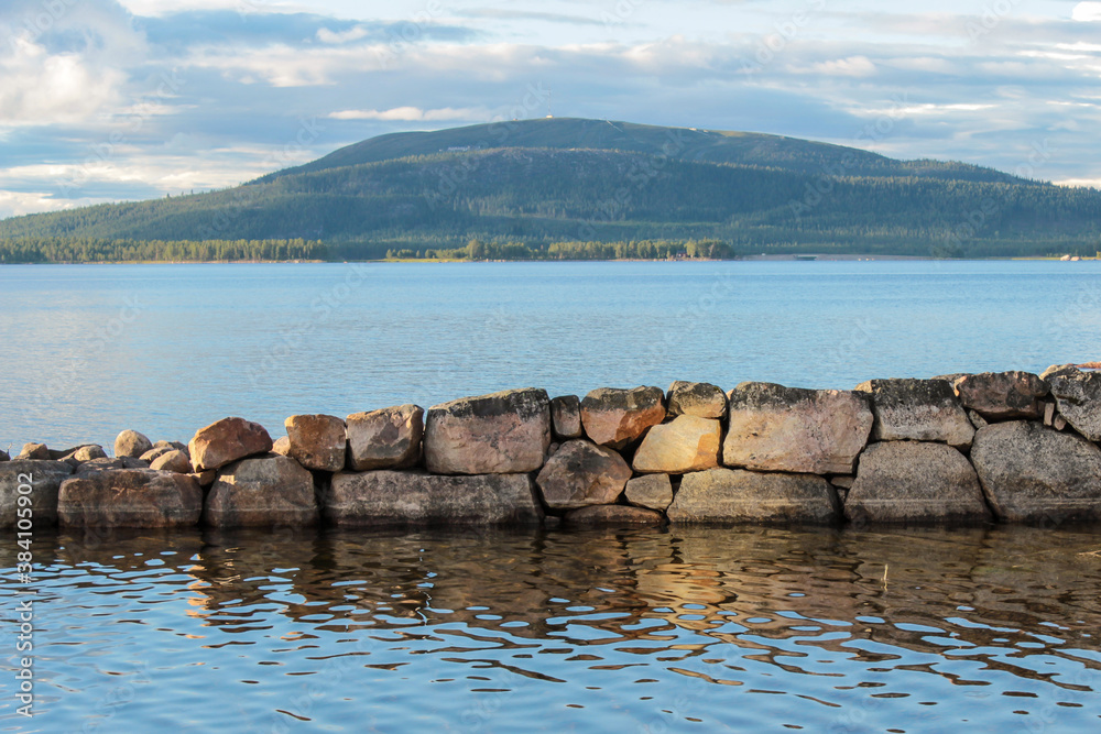 Stone pir in the lake with mountains in the background