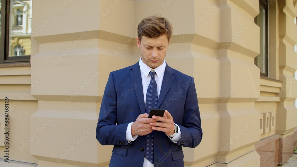 Thinking business man using mobile phone outdoors. Focused executive man Thinking business man using mobile phone outdoors. Focused executive man
