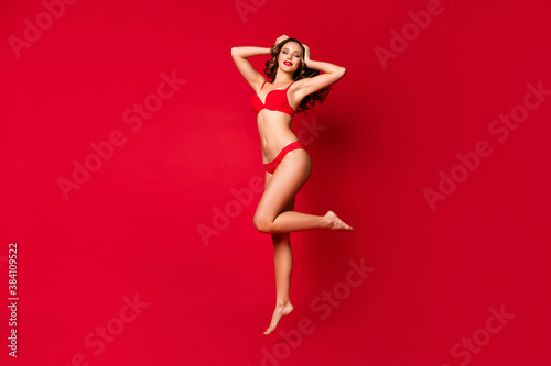 Full size photo of elegant passionate tender nude figure fit trend mistress enjoy perfect body plastic operation jump touch brown curly hair isolated over bright shine color background