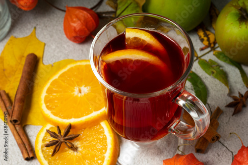 selective focus, hot drink, warmed red wine with fruit from oranges and apples, with spices of anise and cinnamon