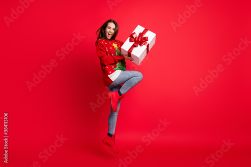 Full length body size view of her she nice attractive pretty glad cheerful girl jumping having fun holding in hands giftbox 14 February isolated bright vivid shine vibrant red color background