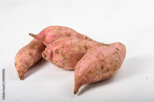 Sweet potatoes on a table isolated on white 