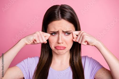 I want home. Closeup photo of displeased crying lady wiping tears arms fingers upset sad gloomy miss parents family wear purple t-shirt isolated pastel pink color background