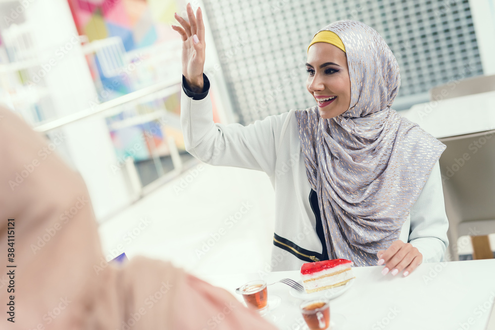 Young Arabian Women Sitting in Cafe in Modern Mall Young Arabian Women Sitting in Cafe in Modern Mall