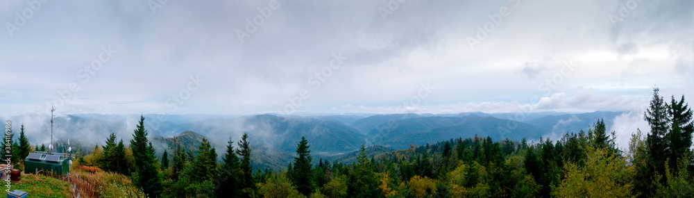 Panorama of the landscape with transmission towers and mountains in the background