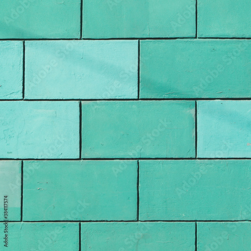 Brick wall is painted mint green color