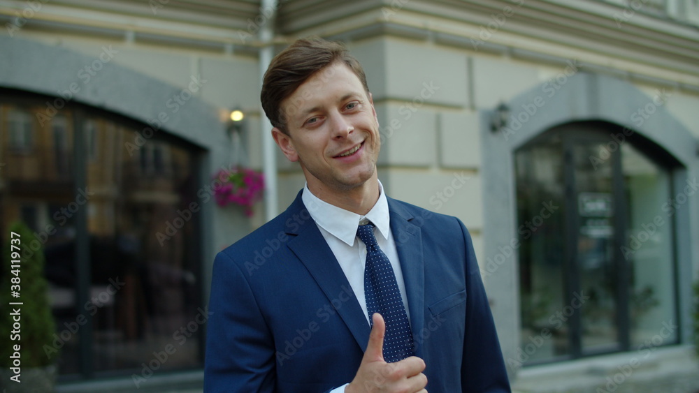 Portrait of smiling business man posing at city street. Successful executive man Portrait of smiling business man posing at city street. Successful executive man