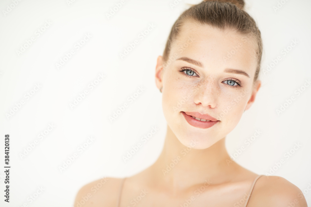 Portrait of beautiful woman with clean skin, youth concept, beauty treatment. Cheerful teen girl, beauty female face happy smiling and looking at camera over white background Portrait of beautiful woman with clean skin, youth concept, beauty treatment. Cheerful teen girl, beauty female face happy smiling and looking at camera over white background