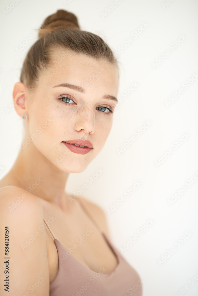 Portrait of beautiful woman with clean skin, youth concept, beauty treatment. Cheerful teen girl, beauty female face happy smiling and looking at camera over white background Portrait of beautiful woman with clean skin, youth concept, beauty treatment. Cheerful teen girl, beauty female face happy smiling and looking at camera over white background