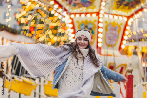 Pretty young woman on a Christmas market. Lightning background, natural emotions. © MyMariaPhotography