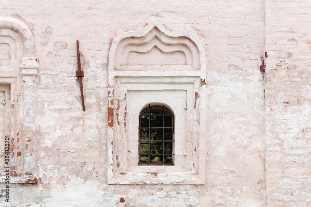 Small window in an ancient white stone wall