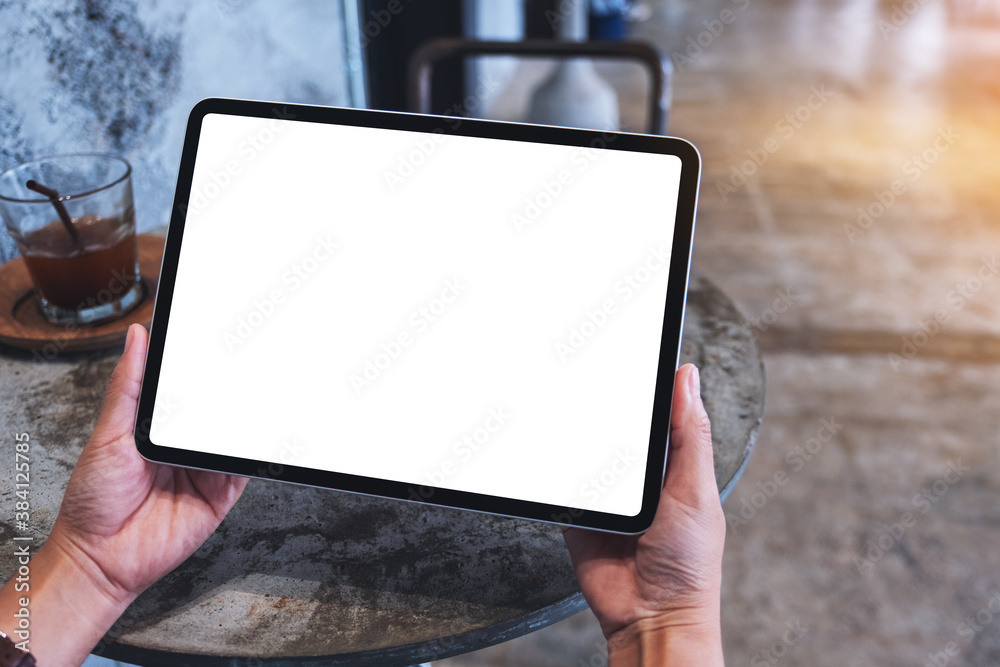 Mockup image of a woman holding digital tablet with blank white desktop screen