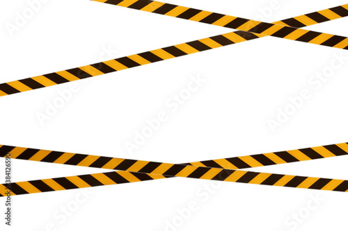 Black and yellow warning lines of barrier tape prohibit passage. Barrier tape on white isolate. Barrier that prohibits traffic. Danger unsafe area warning do not enter. Concept of no entry. Copy space photo