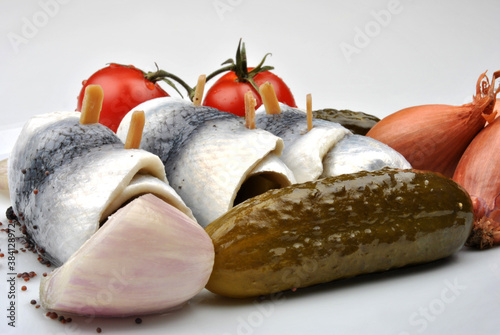 some fresh organic rollmops on a white plate