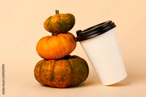 Little pyramid frm pumpkins and coffee cup near it.Spicy latte concept. photo