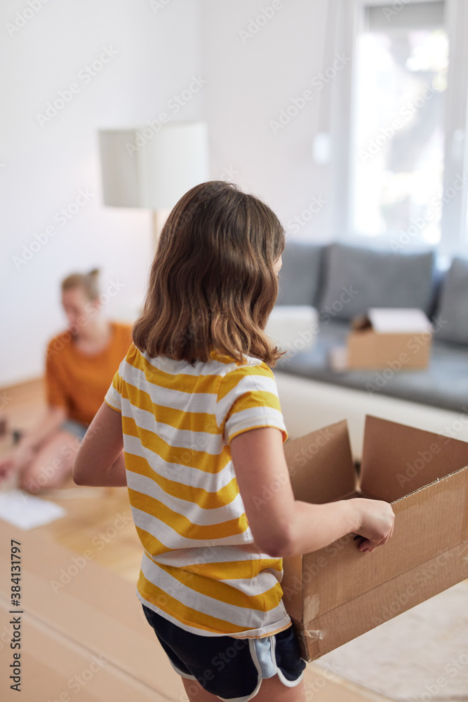 Mother and daughter assembilng new furniture - moving in into a new home. Mother and daughter assembilng new furniture - moving in into a new home.