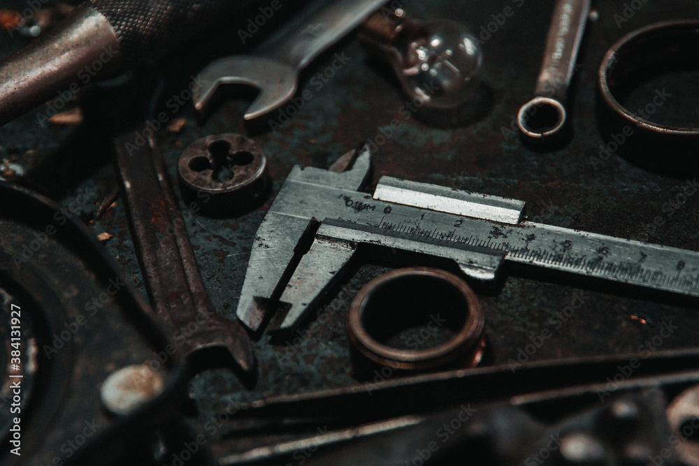 caliper garage old tool on the workbench stand wheel wrenches screwdriver caliper garage old tool on the workbench stand wheel wrenches screwdriver