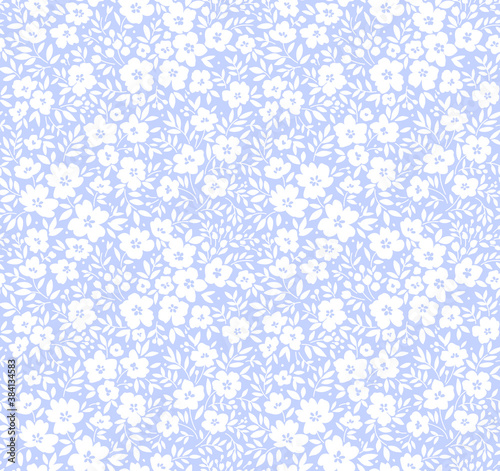 Vintage floral background. Seamless vector pattern for design and fashion prints. Flowers pattern with small white flowers on a light blue background. Ditsy style.
