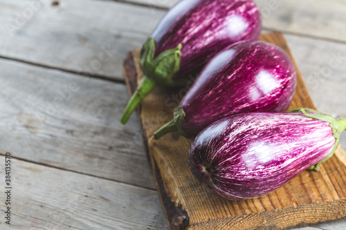 fresh ripe eggplant on wooden board. 