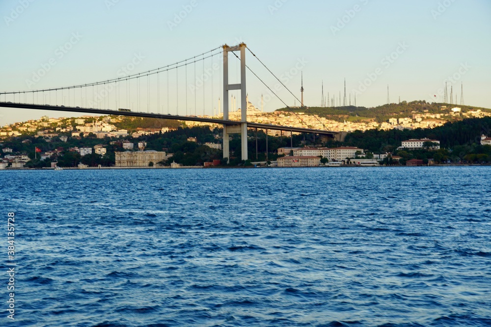 Tourist boats sail under the bridge in Istanbul. Traveling on the Bosphorus. Panoramic view, View of the First Bosphorus Bridge sailling Bosporus. Tourist boats sail under the bridge in Istanbul. Traveling on the Bosphorus. Panoramic view, View of the First Bosphorus Bridge sailling Bosporus.
