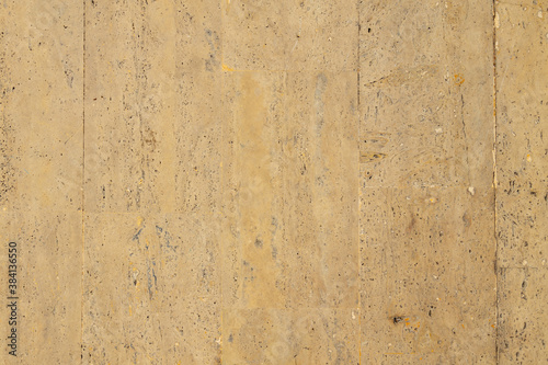 Yellow limestone tiles pool surface closeup texture background.