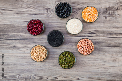 Cereal grains seeds beans on wooden background. Whole grains and bean. Cereals and beans. Different dry legumes for eating healthy. Peanut , Black bean, Red Bean. Green Bean, Soybean, sesame