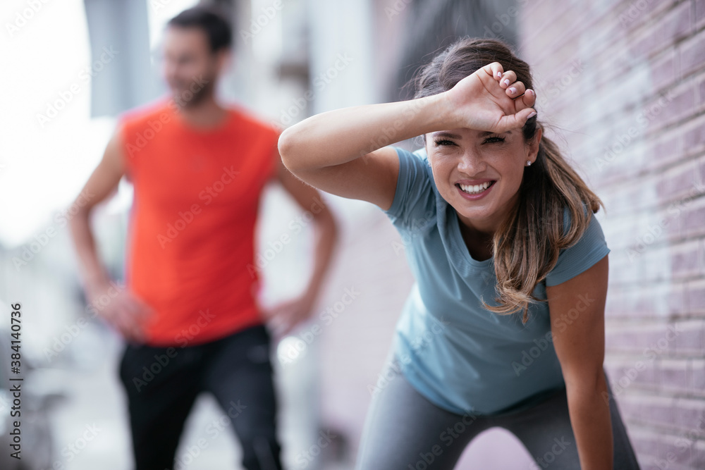 A young woman stretching before a run. Beautiful woman training outdoors. A young woman stretching before a run. Beautiful woman training outdoors.
