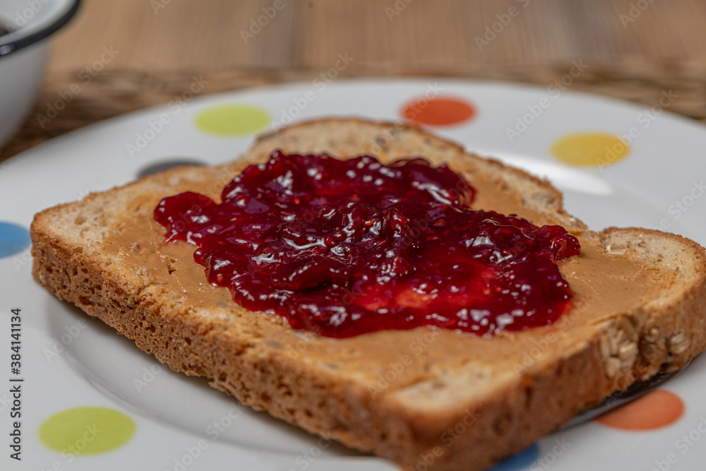 Breakfast. Peanut butter and raspberry jelly sandwich on wooden background. Breakfast. Peanut butter and raspberry jelly sandwich on wooden background.