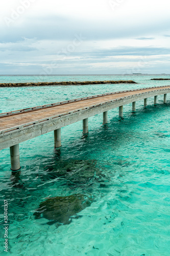 Fototapeta Naklejka Na Ścianę i Meble -  Wooden pier going to horizon in Indian ocean on Maldive islands