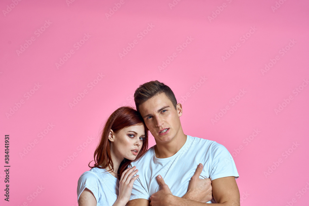 enamored man and woman hugging each other on a pink background cropped with Copy Space family portrait enamored man and woman hugging each other on a pink background cropped with Copy Space family portrait