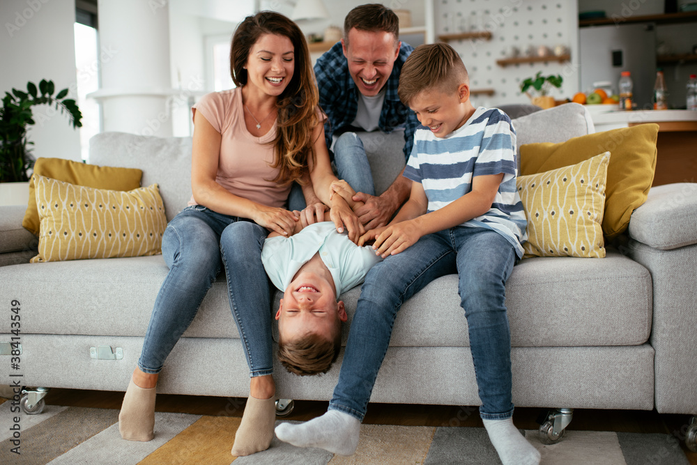 Young family enjoying at home. Happy parents with sons having fun... Young family enjoying at home. Happy parents with sons having fun...
