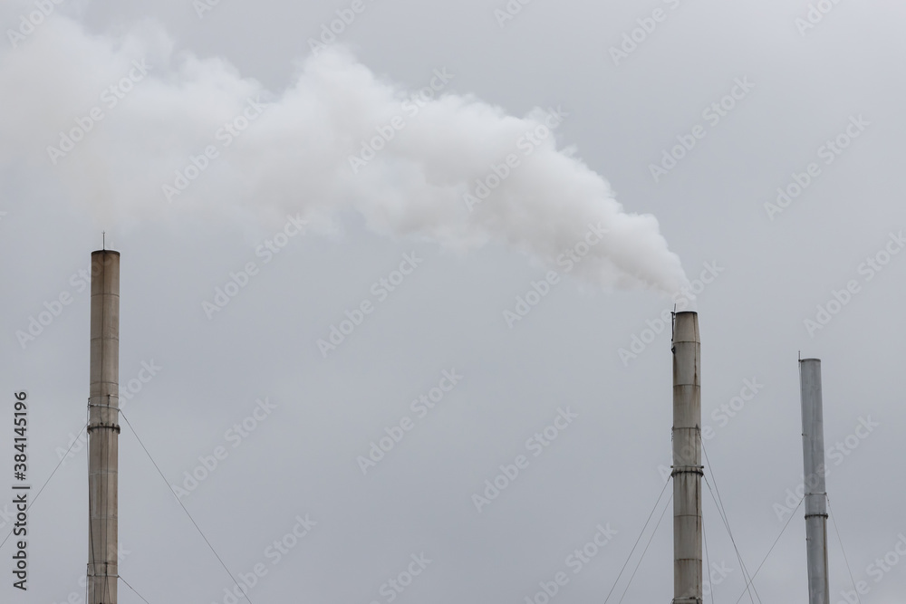 white smoke from steel chimney of factory on cloudy sky. white smoke from steel chimney of factory on cloudy sky.