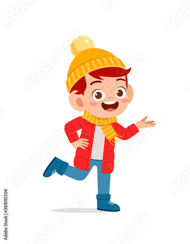 happy cute little kid play and wear jacket in winter season. child smile wearing warm clothes