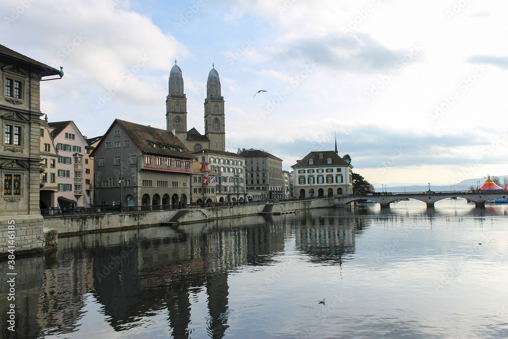 Famous Grossmunster church in historic city center , and Limmat river in Zurich, Switzerland.