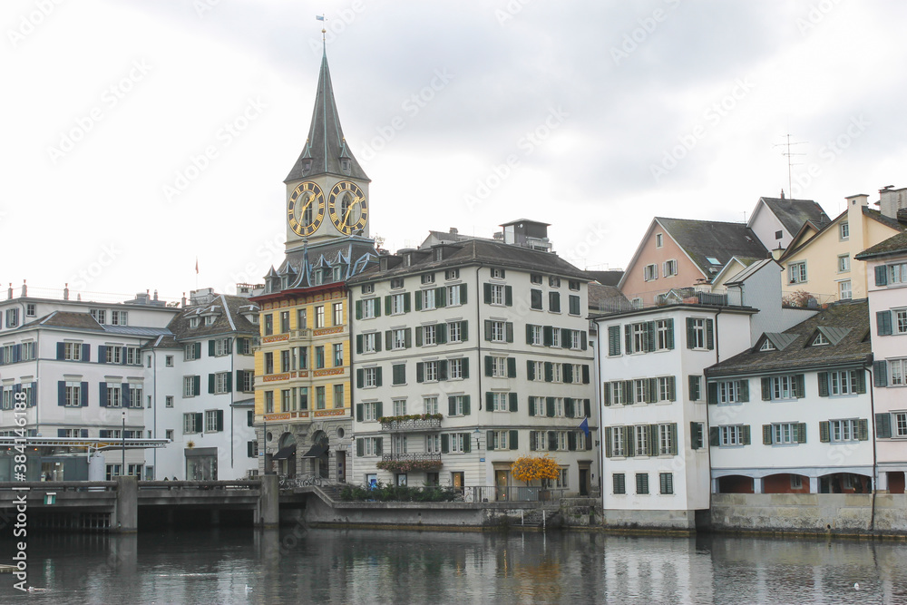 Beautiful view of the St Peter's Church , historic city center , and Limmat river in Zurich, Switzerland.