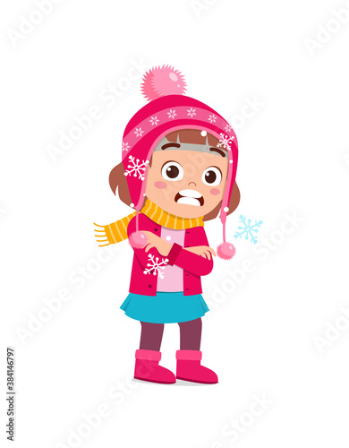 happy cute little kid play and wear jacket in winter season. child feeling chill wearing warm clothes