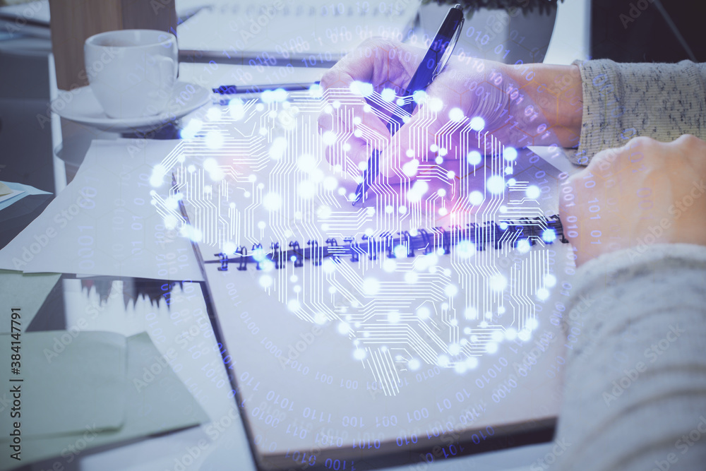 Double exposure of writing hand on background with brain hologram. Concept of learning. Double exposure of writing hand on background with brain hologram. Concept of learning.