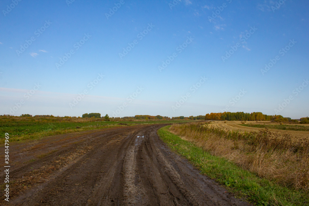 Rural landscape in early autumn. Poles, mowed grass, fields and meadows. Small villages and farms