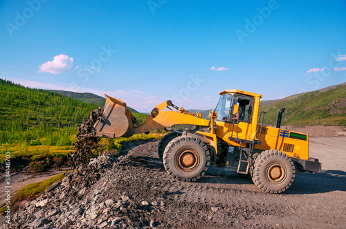 Wheel loader during earthworks in mountainous area - Mining