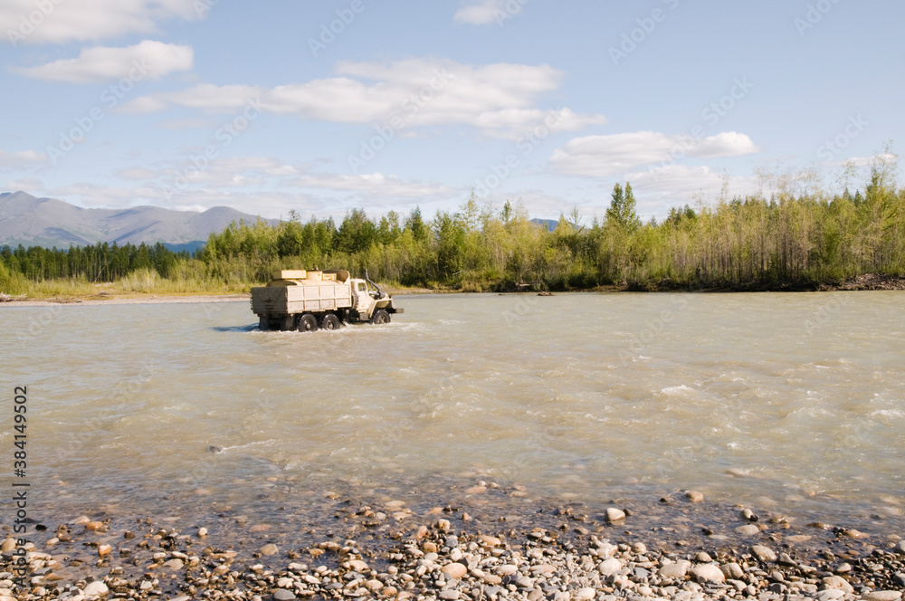 A gasoline tanker crosses a river in a wooded mountainous area in Eastern Siberia; a common sight in remote areas of Siberia, where there are still very few roads and bridges A gasoline tanker crosses a river in a wooded mountainous area in Eastern Siberia; a common sight in remote areas of Siberia, where there are still very few roads and bridges