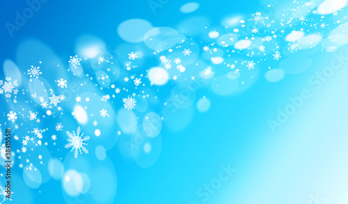 blue Christmas background with snowflakes and glittery light 