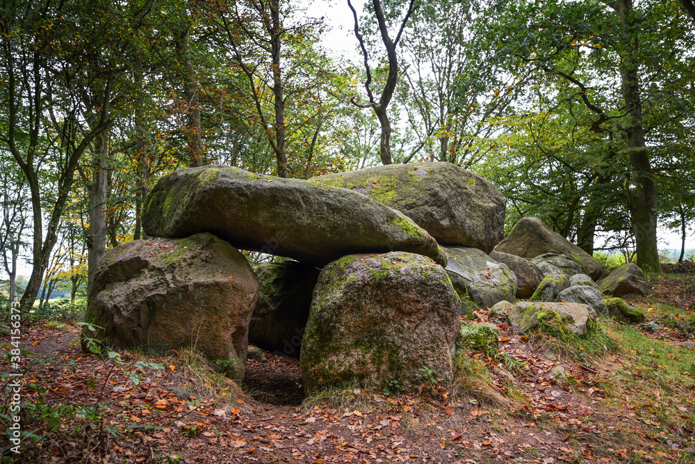Prehistoric megalithic tomb or dolmen, an excavated and reconstructed passage grave from larges stones in the forest of Klein Gornow, Sternberg, Germany Prehistoric megalithic tomb or dolmen, an excavated and reconstructed passage grave from larges stones in the forest of Klein Gornow, Sternberg, Germany