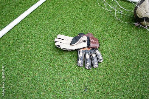 Football goalkeeper gloves on the grass