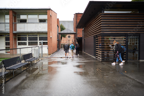 Kids walking to school on a rainy day