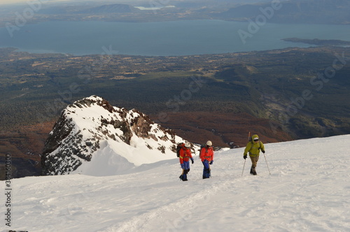 Mountain climbing during the sunrise on the snow covered active Volcan Villarrica in Pucon, Chile photo