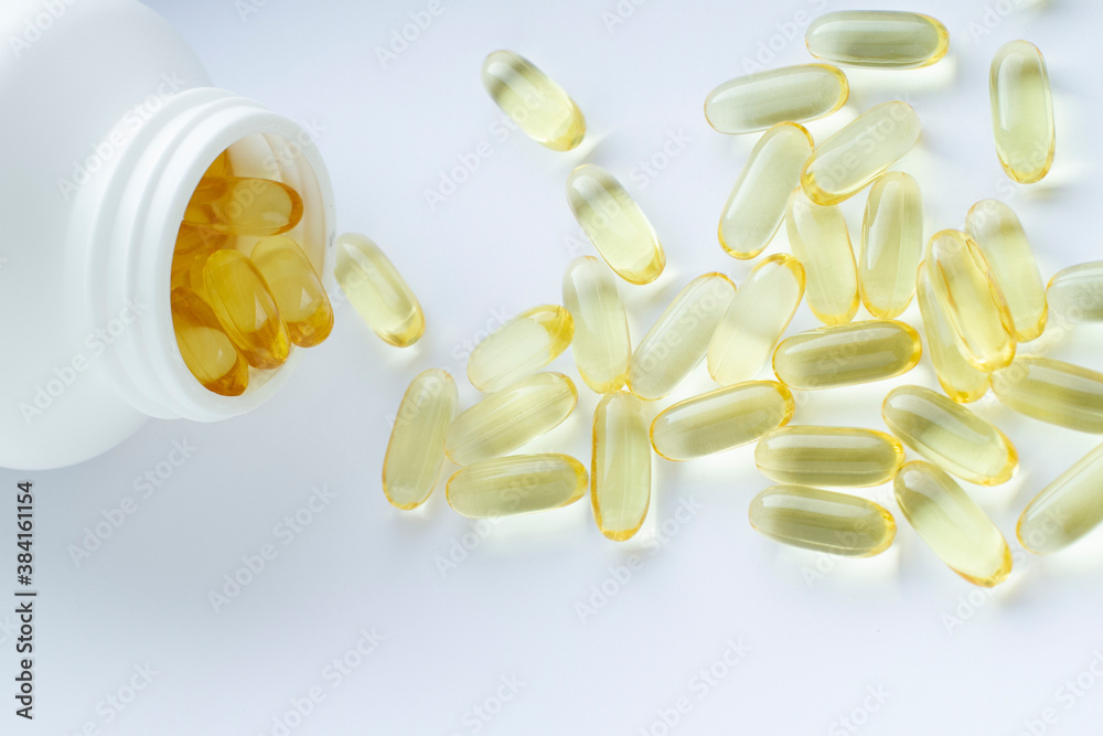 Omega 3 capsules and bottle on white background. Health support, vitamins and treatment. Omega 3 capsules and bottle on white background. Health support, vitamins and treatment.