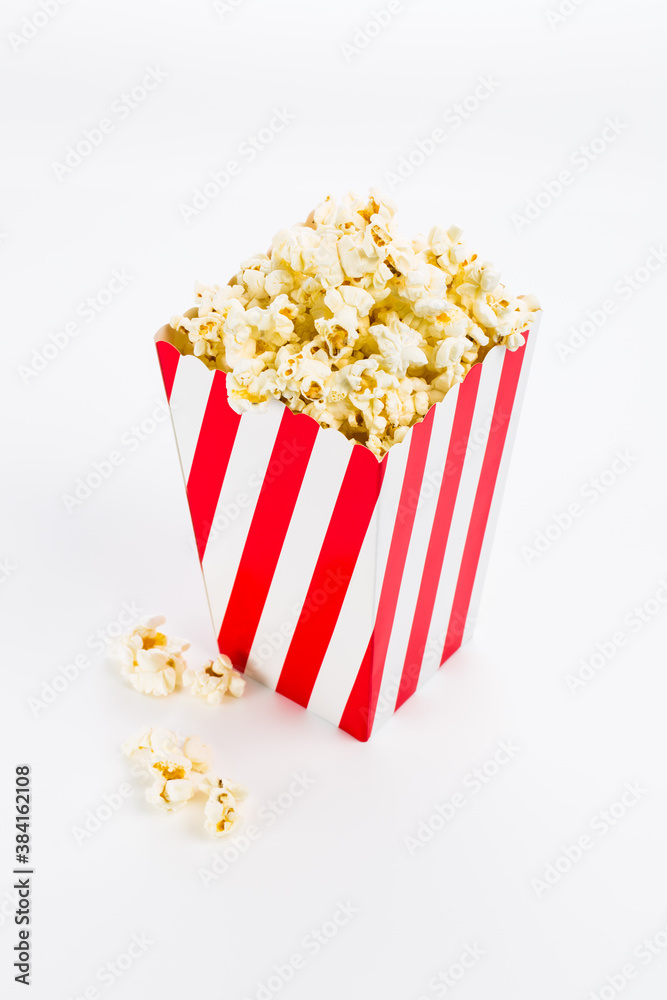 Red and white Popcorn box filled with popcorn on white background Red and white Popcorn box filled with popcorn on white background