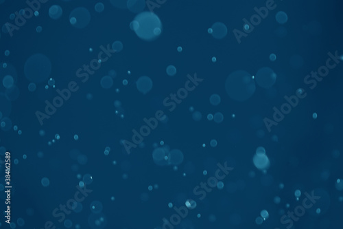abstract blue bokeh background with light dot pattern.
