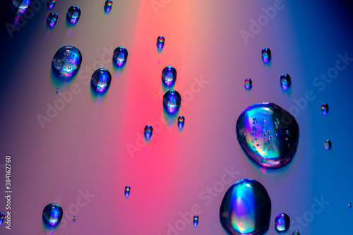 Water drops on a rainbow background.