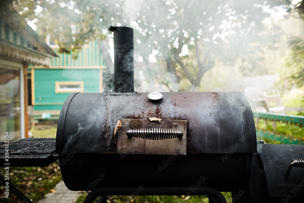 Outdoor barbecue grill. The smoke from cooking rises into the sky